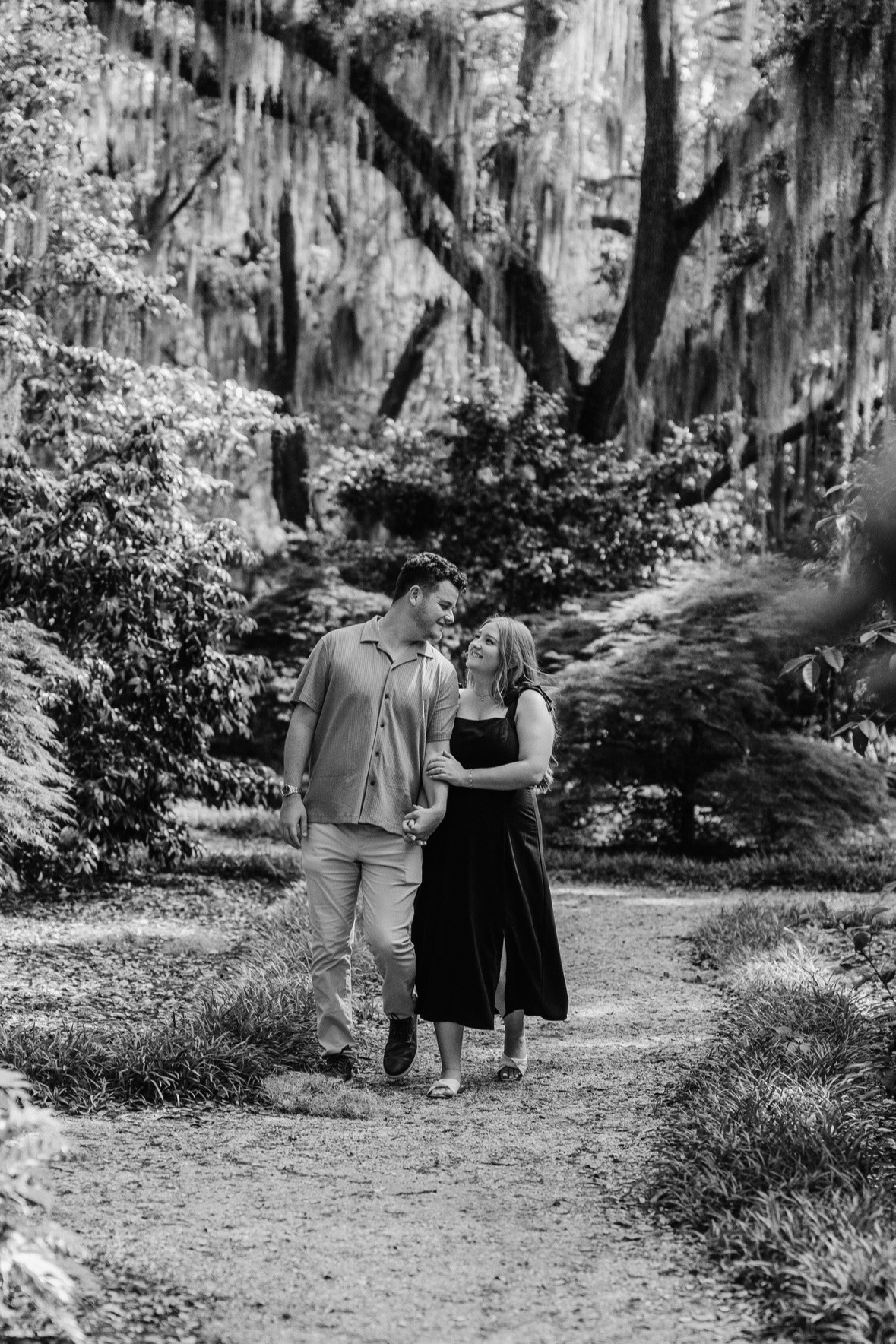 Megan and Spencer walking through Airlie Gardens